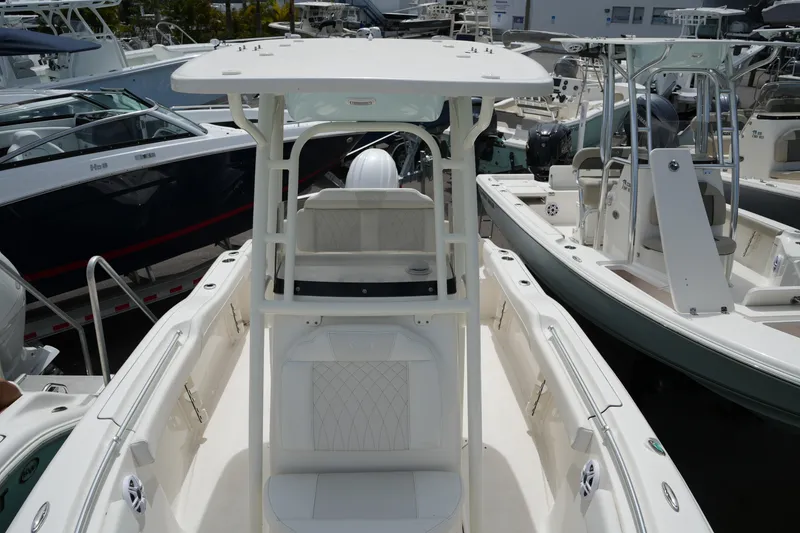 Slide: The Image of 2026 Key West 219 FS boat with T-top, docked among other boats. - 25
