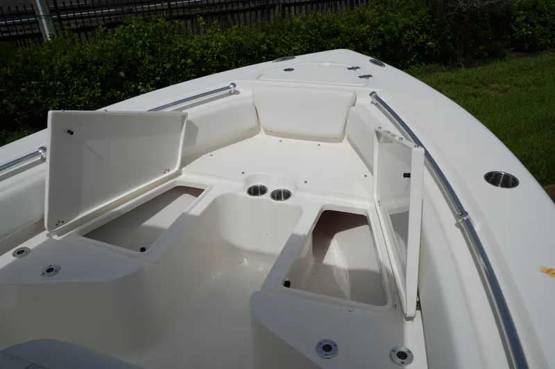 Slide: The Image of 2026 Key West 219 FS boat interior with open storage compartments and cup holders. - 26