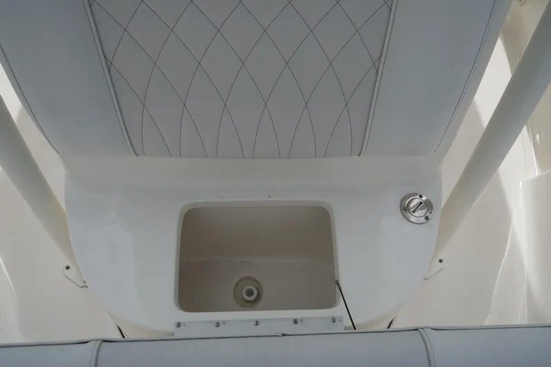 Slide: The Image of 2026 Key West 219 FS boat interior with storage compartment and cushioned seating. - 27