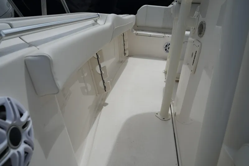 Slide: The Image of Interior view of 2026 Key West 219 FS boat, featuring white seating and speakers. - 29