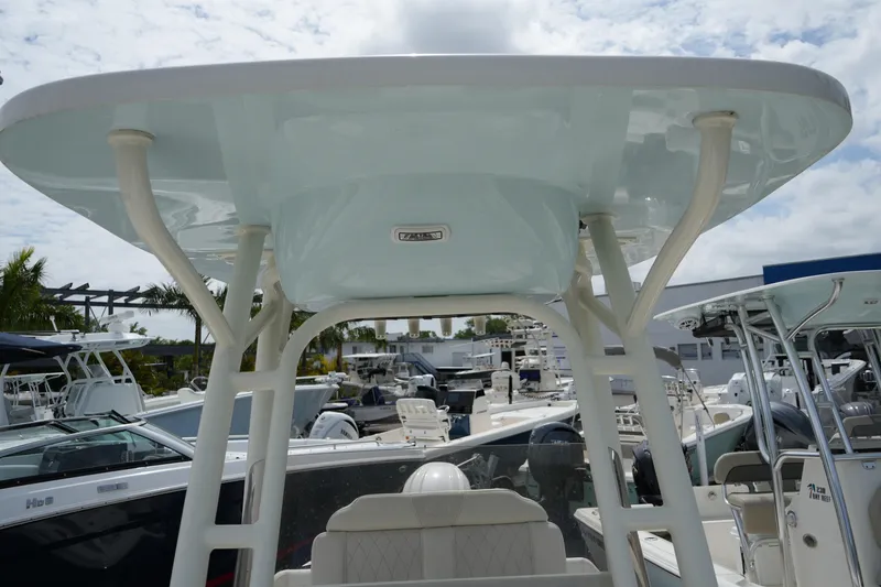 Slide: The Image of 2026 Key West 219 FS boat with T-top, displayed in a marina setting. - 30