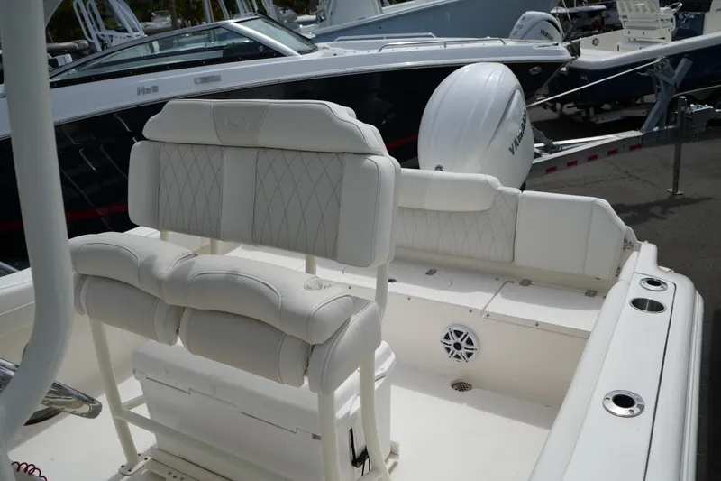 Slide: The Image of 2026 Key West 219 FS boat interior with white cushioned seating and Yamaha engine. - 33