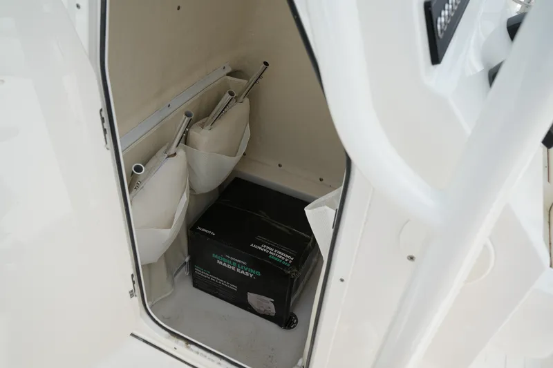 Slide: The Image of Storage compartment in 2026 Key West 219 FS boat with organized equipment and box. - 34