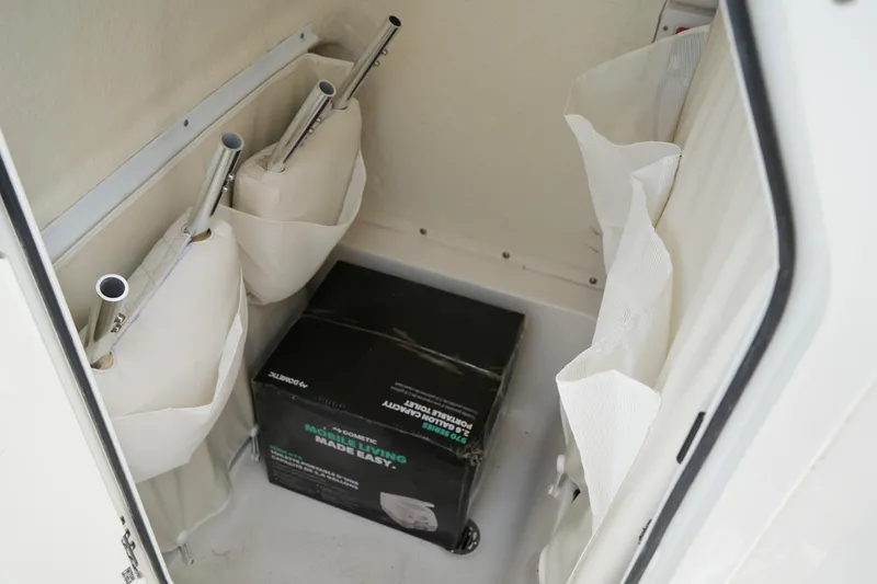 Slide: The Image of Storage compartment in 2026 Key West 219 FS boat with equipment and box. - 35