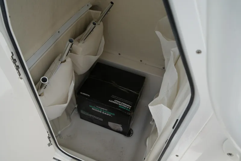 Slide: The Image of Storage compartment in a 2026 Key West 219 FS boat with organized equipment. - 36