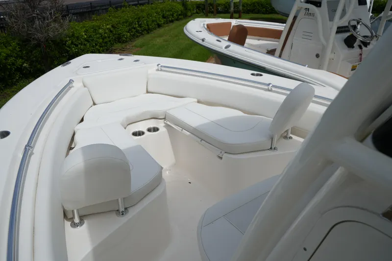 Slide: The Image of 2026 Key West 219 FS boat interior with white seating and cup holders. - 37