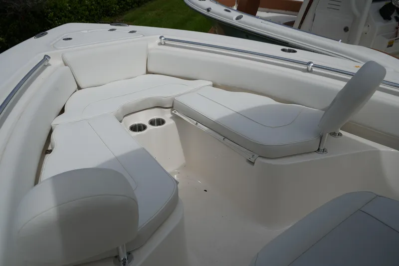 Slide: The Image of 2026 Key West 219 FS boat interior with white cushioned seating and cup holders. - 38