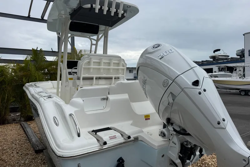 Slide: The Image of 2026 Key West 219 FS boat with Yamaha 200 engine, docked outdoors. - 4