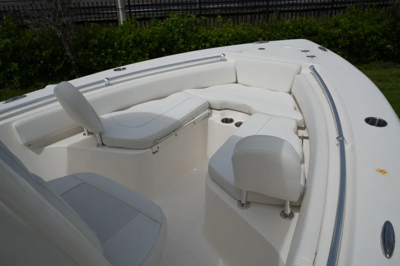 Slide: The Image of 2026 Key West 219 FS boat interior with white seating and cup holders. - 40