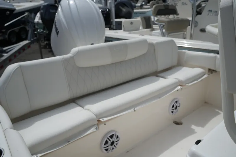 Slide: The Image of 2026 Key West 219 FS boat interior with white cushioned seating and speakers. - 42
