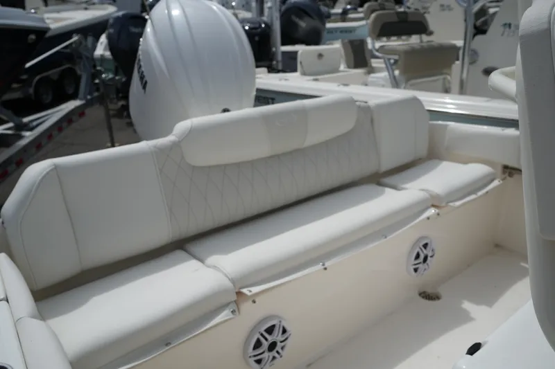 Slide: The Image of 2026 Key West 219 FS boat interior with white cushioned seating and speakers. - 43