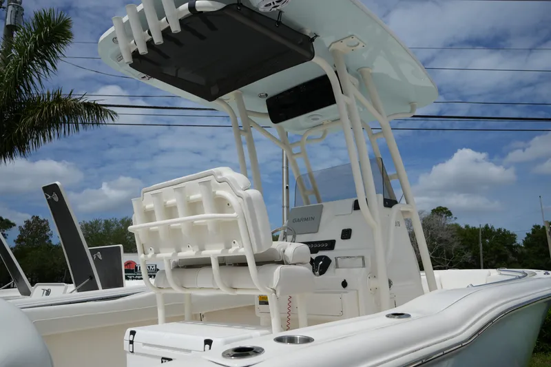 Slide: The Image of 2026 Key West 219 FS boat with T-top and Garmin electronics under a blue sky. - 7
