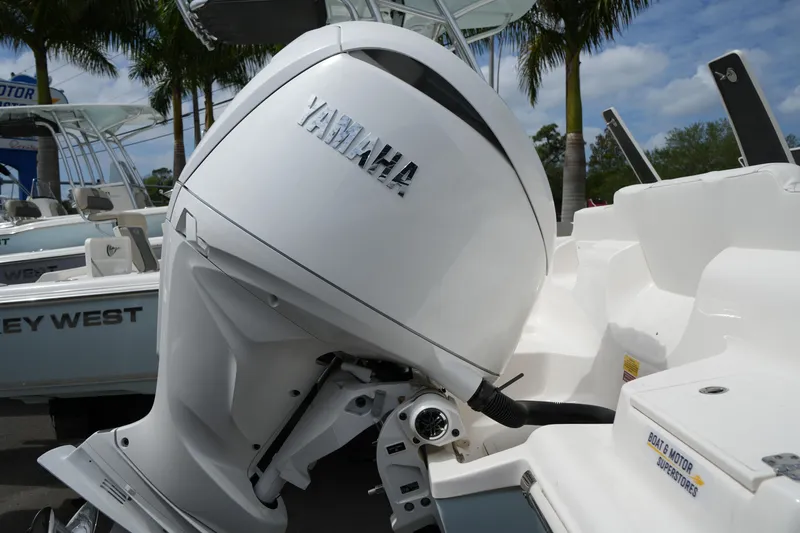 Slide: The Image of 2026 Key West 219 FS boat with Yamaha outboard motor, palm trees in background. - 8