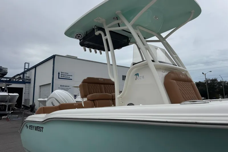 Slide: The Image of 2026 Key West 219 FS boat with brown seating, parked near service department. - 11