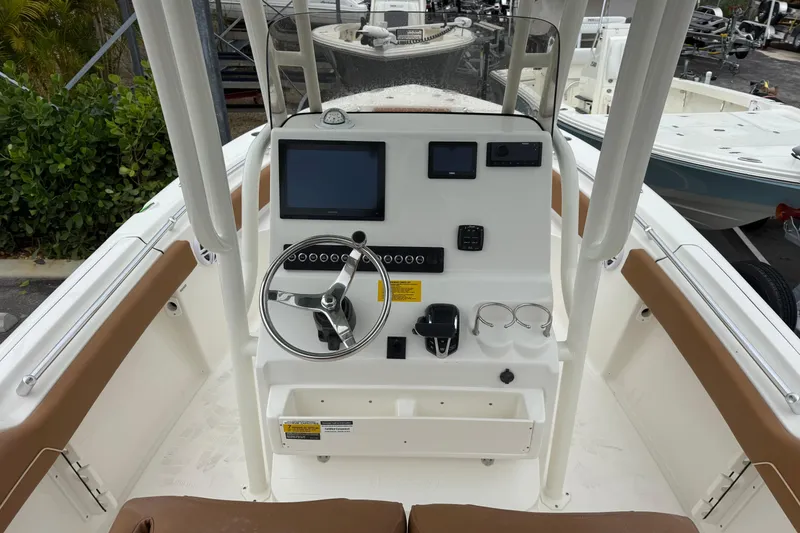 Slide: The Image of 2026 Key West 219 FS boat dashboard with steering wheel and navigation screens. - 15