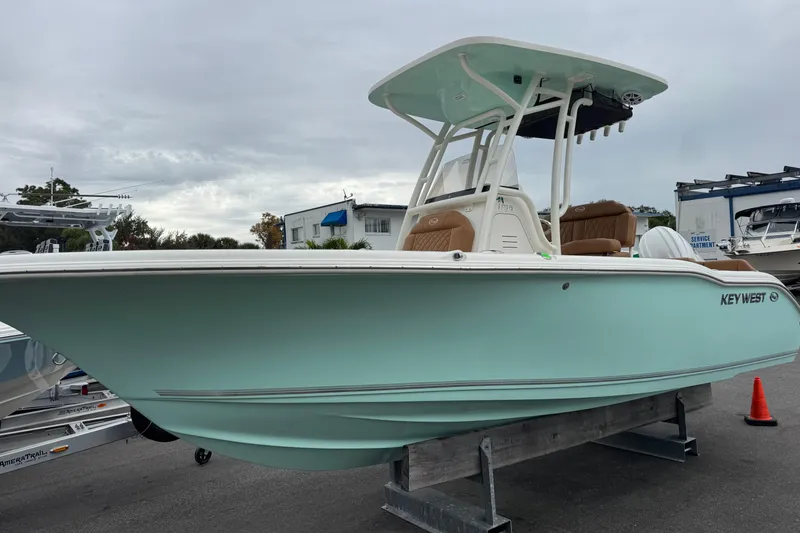 The Image of 2026 Key West 219 FS boat displayed outdoors on a stand, overcast sky. - 3