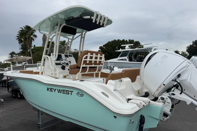 Slide: The Image of 2026 Key West 219 FS boat with Yamaha engine, parked outdoors. - 4