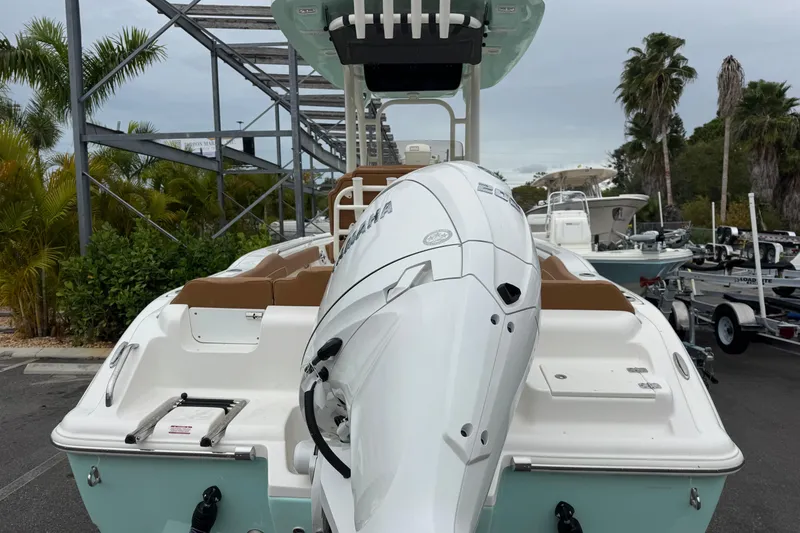 Slide: The Image of 2026 Key West 219 FS boat with Yamaha outboard motor, docked near palm trees. - 5