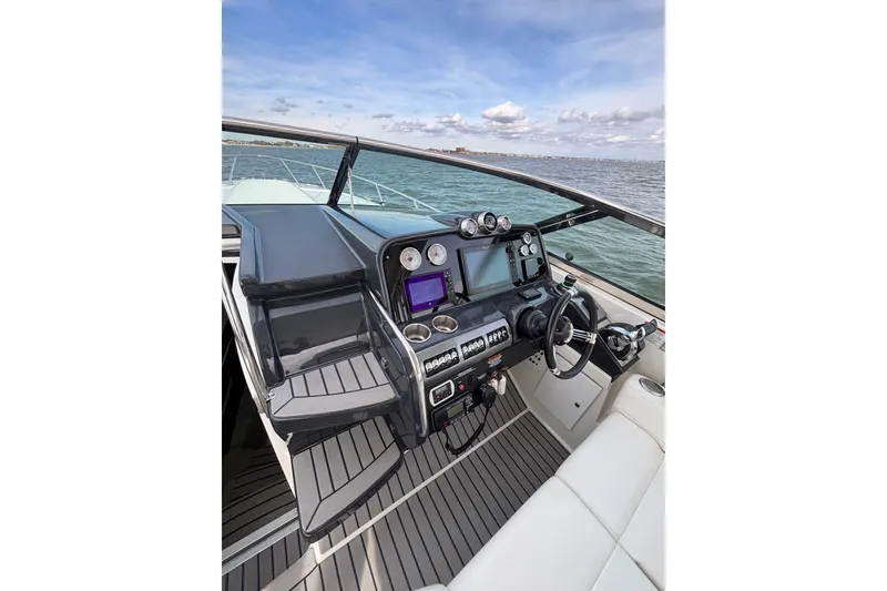Slide: The Image of 2017 Formula 370 Super Sport boat cockpit with modern controls and ocean view. - 10