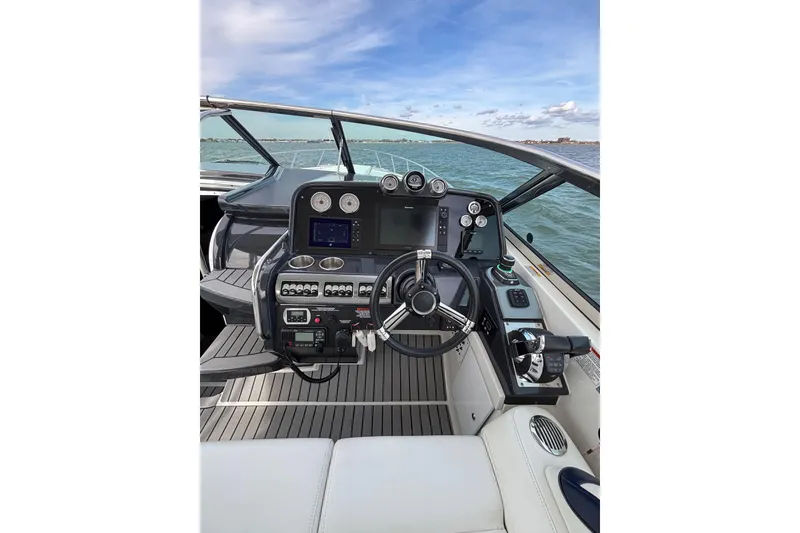 Slide: The Image of Cockpit of 2017 Formula 370 Super Sport boat with steering wheel and controls. - 11