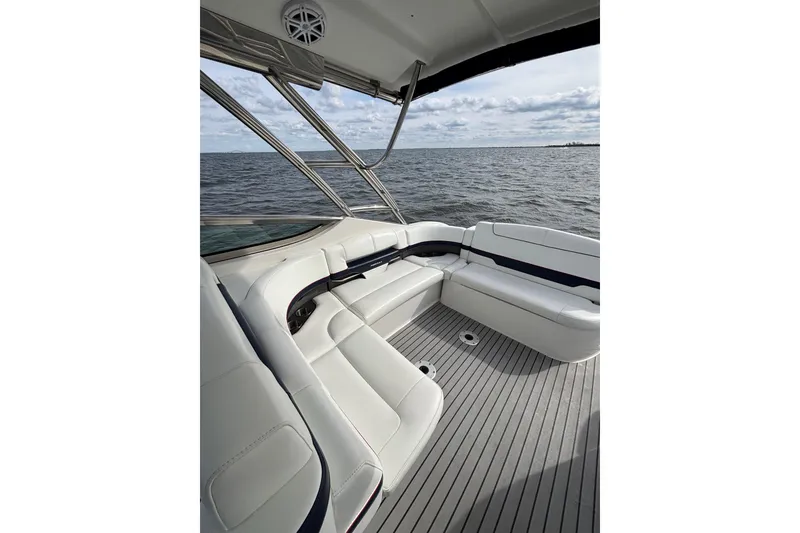 Slide: The Image of 2017 Formula 370 Super Sport boat interior with white seating, ocean view. - 12