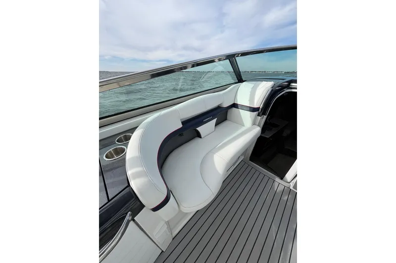 Slide: The Image of 2017 Formula 370 Super Sport boat interior with white seating and ocean view. - 16