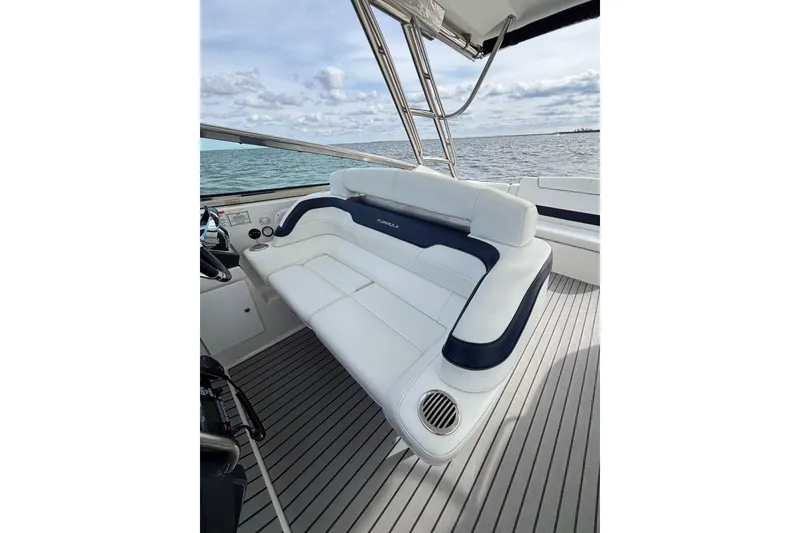 Slide: The Image of 2017 Formula 370 Super Sport boat interior with white seating and ocean view. - 17