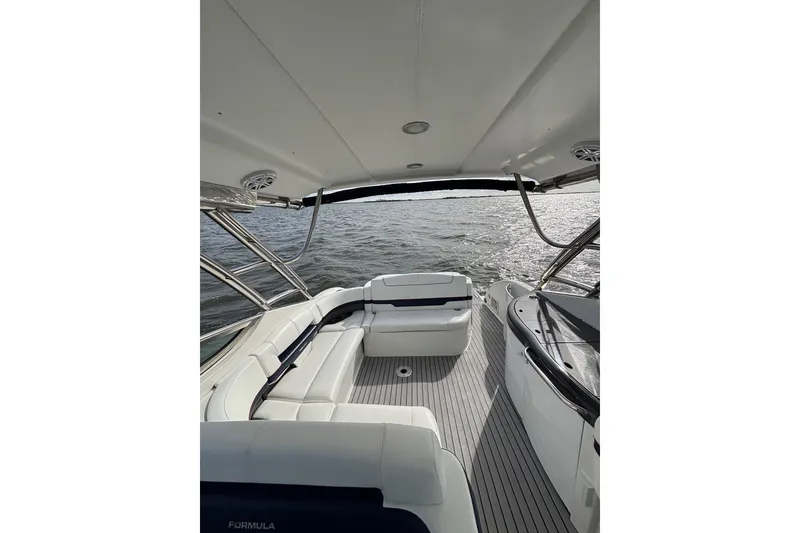 Slide: The Image of 2017 Formula 370 Super Sport boat interior with white seating and ocean view. - 18