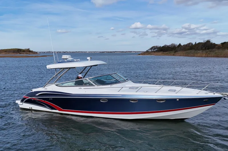 Slide: The Image of 2017 Formula 370 Super Sport boat cruising on a calm lake under a clear sky. - 2