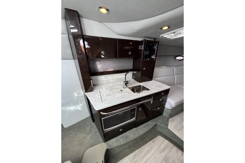 Slide: The Image of 2017 Formula 370 Super Sport yacht interior with modern kitchenette and sleek cabinetry. - 23