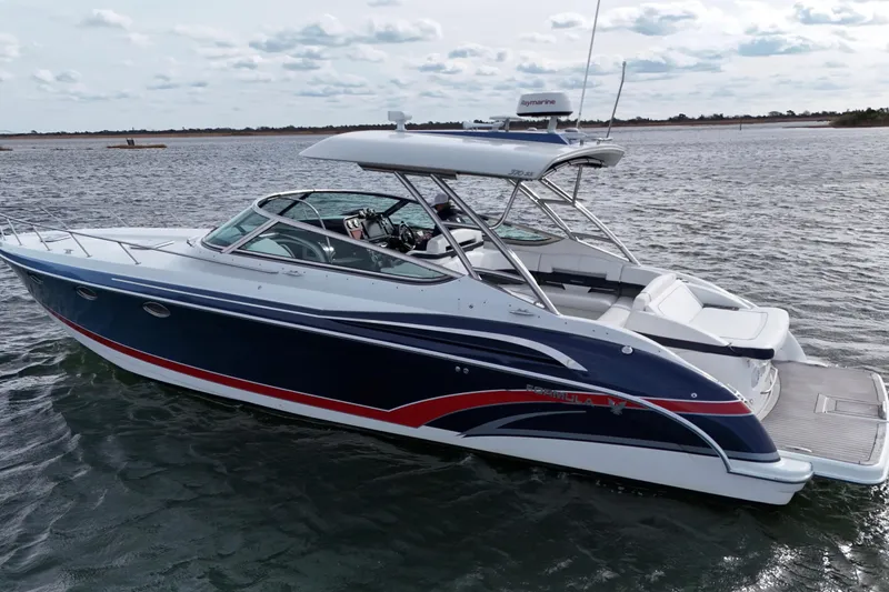 Slide: The Image of 2017 Formula 370 Super Sport boat on water, sleek design, blue and white exterior. - 3