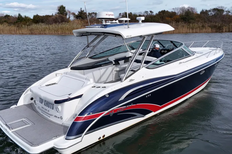 Slide: The Image of 2017 Formula 370 Super Sport boat cruising on a calm lake. - 4