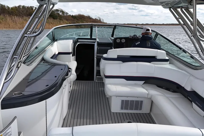 Slide: The Image of 2017 Formula 370 Super Sport boat interior with seating and helm on a calm lake. - 9