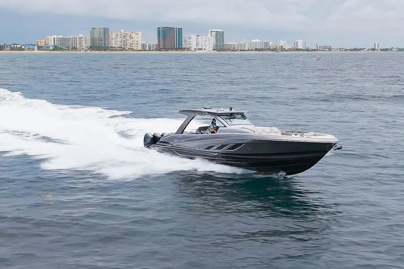 Slide: The Image of 2026 Deep Impact 499 Sport boat cruising near city skyline on open water. - 11