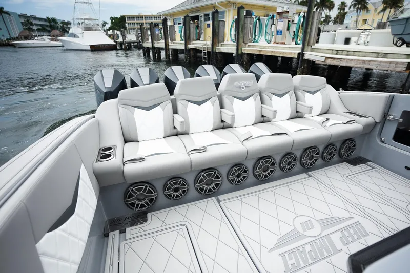 Slide: The Image of Luxury seating on 2026 Deep Impact 499 Sport boat, docked at marina. - 32