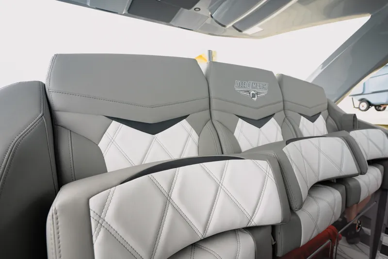 Slide: The Image of Luxurious seating in 2026 Deep Impact 499 Sport boat, featuring elegant gray and white upholstery. - 52