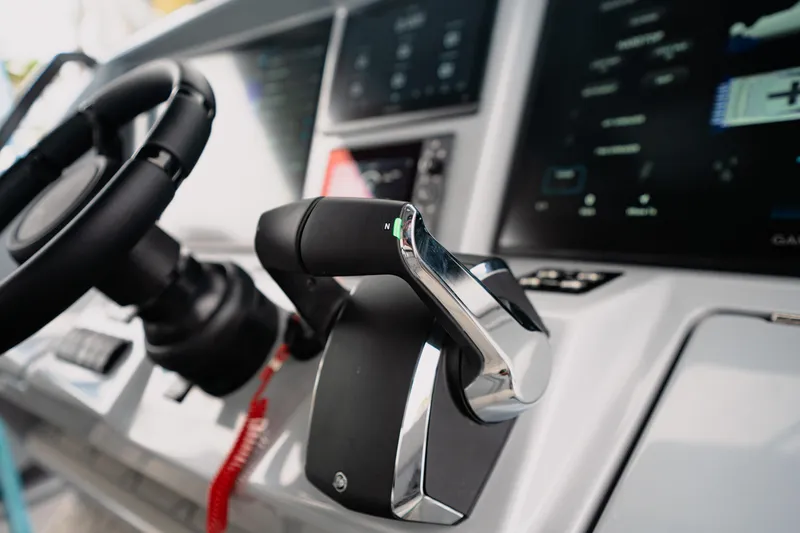 Slide: The Image of Close-up of 2026 Deep Impact 499 Sport boat controls and steering wheel. - 53