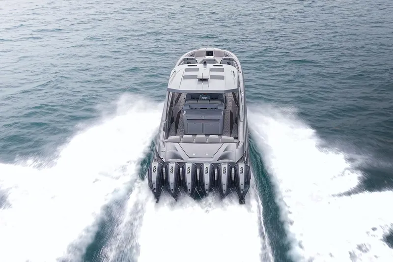 Slide: The Image of 2026 Deep Impact 499 Sport boat cruising on open water, rear view. - 6