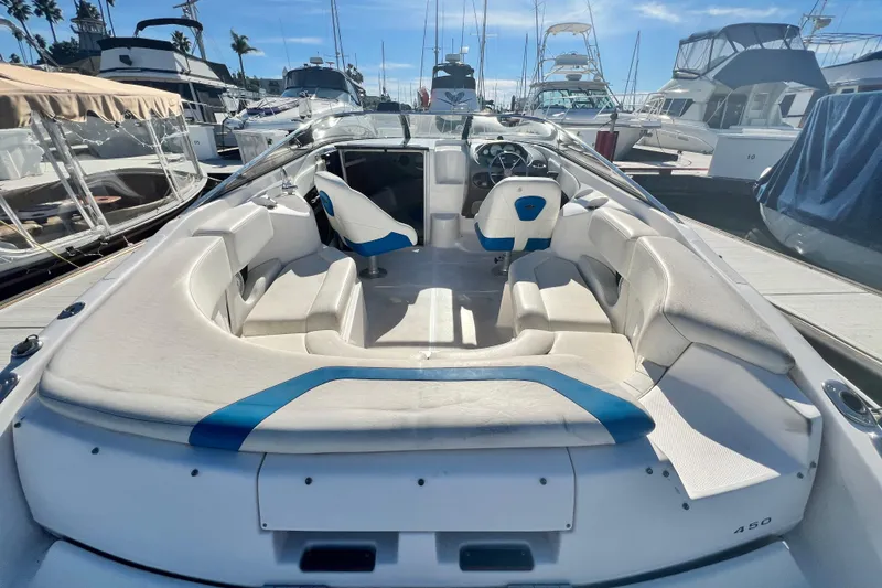 Slide: The Image of 2006 Regal Marine 2650 Cuddy boat interior with white seating at marina. - 10