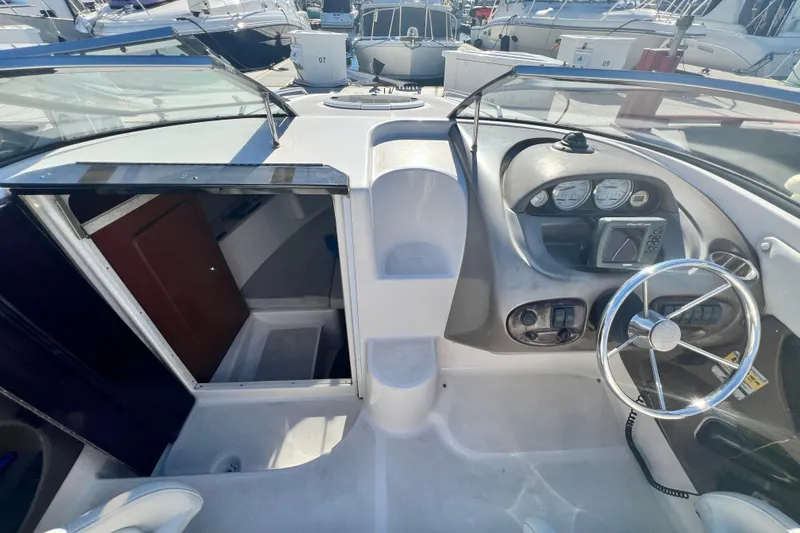 Slide: The Image of 2006 Regal Marine 2650 Cuddy boat interior with steering wheel and cabin entrance. - 12