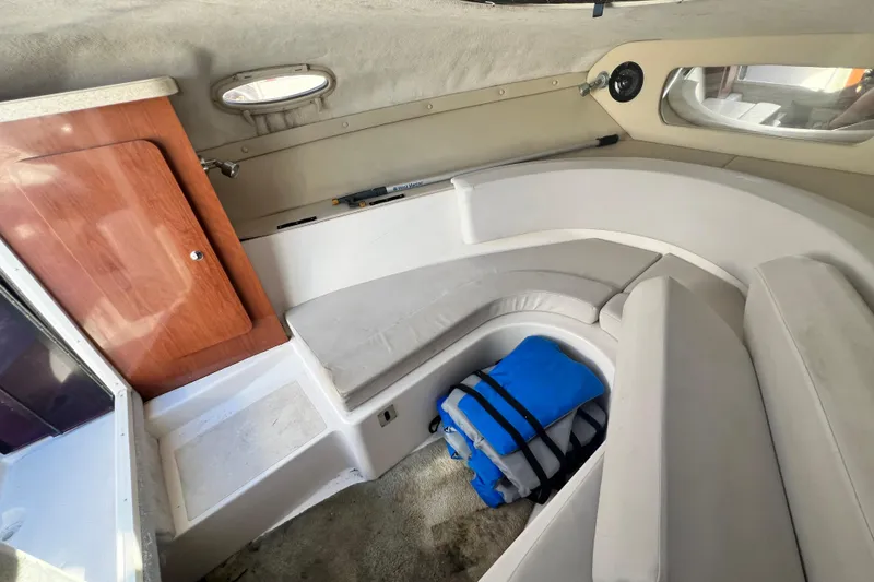 Slide: The Image of 2006 Regal Marine 2650 Cuddy cabin interior with seating and life jackets. - 14