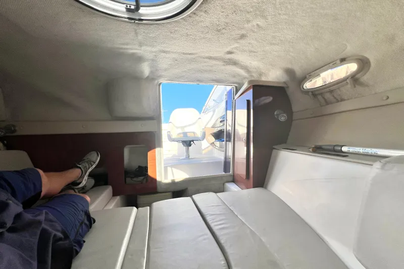 Slide: The Image of Interior view of 2006 Regal Marine 2650 Cuddy cabin with seating and portholes. - 15