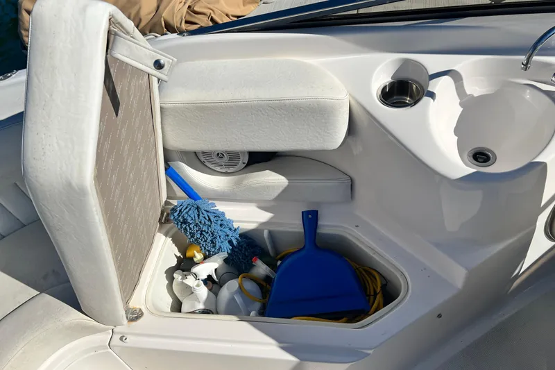 Slide: The Image of 2006 Regal Marine 2650 Cuddy boat interior storage with cleaning supplies and cup holder. - 16