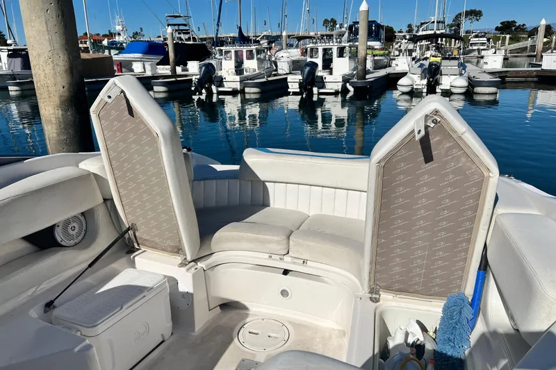 Slide: The Image of 2006 Regal Marine 2650 Cuddy boat interior with seating and marina view. - 17