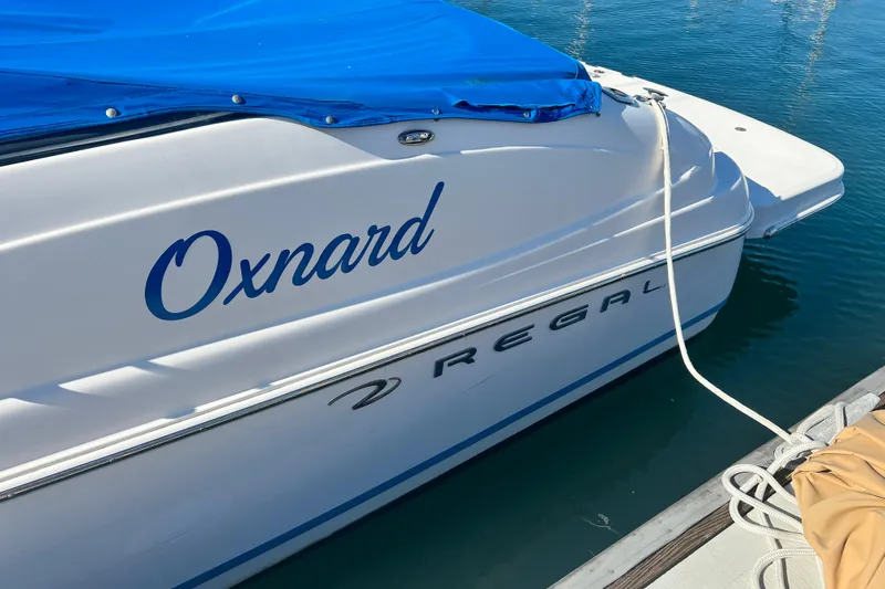 Slide: The Image of 2006 Regal Marine 2650 Cuddy boat docked with blue cover in Oxnard. - 5
