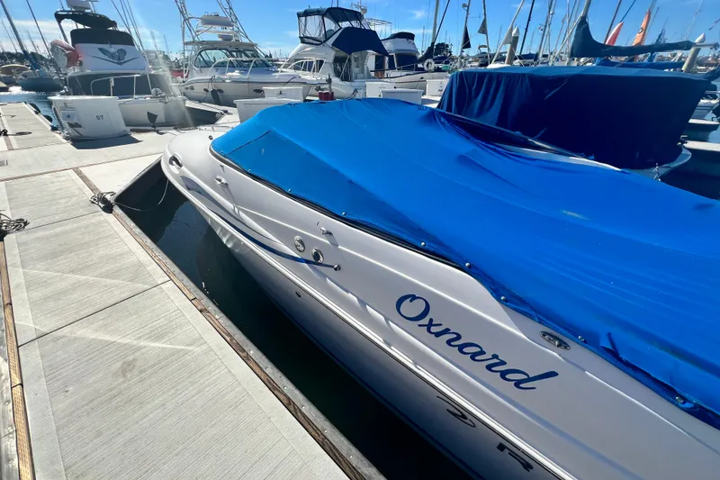 Slide: The Image of 2006 Regal Marine 2650 Cuddy boat docked with blue cover in marina. - 6