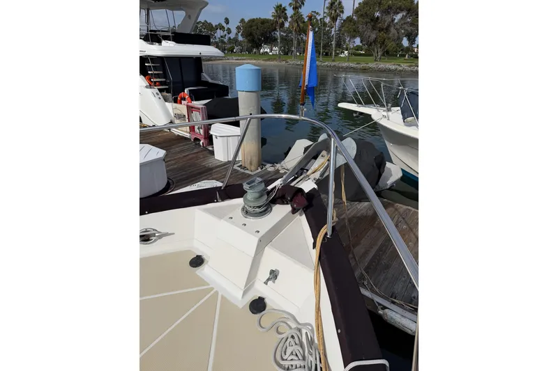 Slide: The Image of 1988 Offshore Yachts 48 Sedan docked, showing bow and deck details. - 13