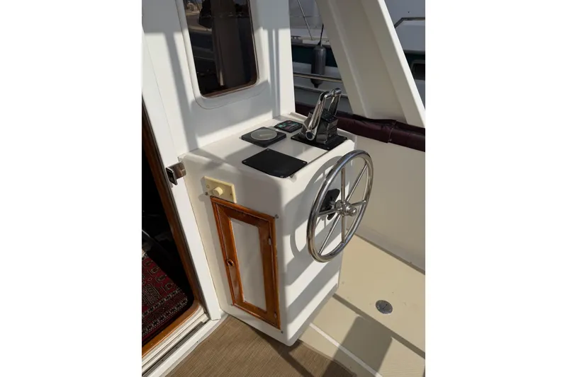 Slide: The Image of Helm station of 1988 Offshore Yachts 48 Sedan with steering wheel and controls. - 21