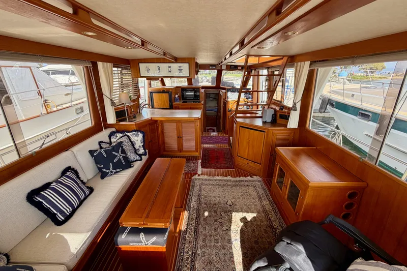 Slide: The Image of Interior of 1988 Offshore Yachts 48 Sedan, featuring cozy seating and nautical decor. - 22