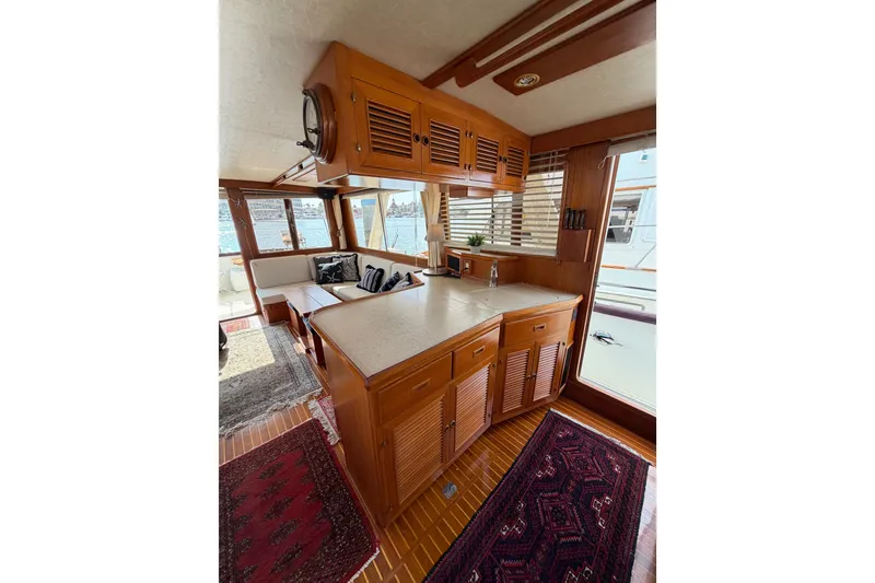 Slide: The Image of Interior of 1988 Offshore Yachts 48 Sedan, featuring wood cabinetry and nautical decor. - 31